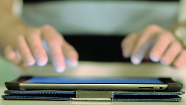 Close Up Hand Typing On Tablet Computer Screen