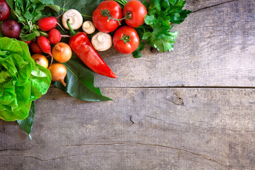Fresh ripe vegetables on wooden table background