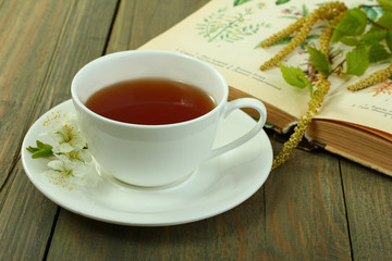 Cup of tea and cherry with  honeycomb on a wooden background