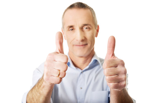 Portrait of mature man gesturing ok sign