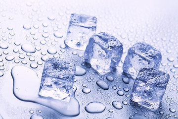 melting ice cubes on blue background