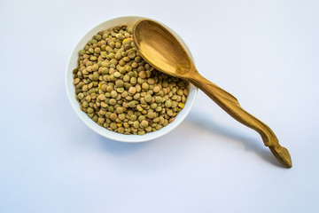 raw lentil, bob in bowl and wooden spoon