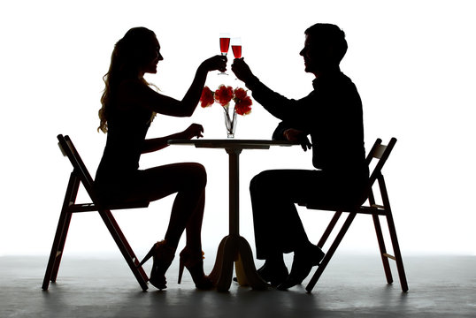 Couple Having Dinner With Wine Glass On Table