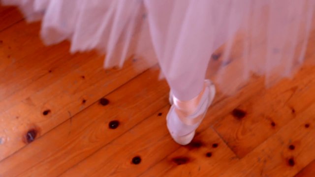 young ballerina dancing on the parquet block (hall) -foot