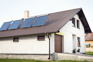 Fototapeta na wymiar Vacuum solar water heating system on a house roof.