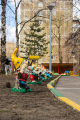 Fototapeta na wymiar Garden gnomes figures in the courtyard of the kindergarten
