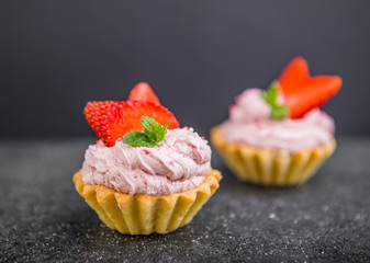Small biscuits with strawberries and sweet cream