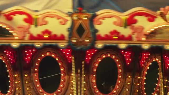 CU Illuminated carousel spinning at night / American Fork City, Utah, USA