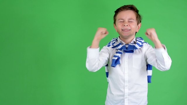 young handsome child boy rejoices - green screen - studio