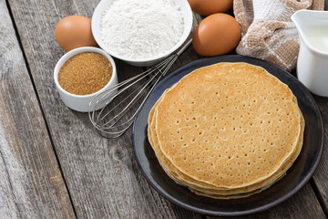 crepes and ingredients for their preparation, top view