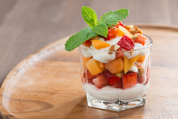 fruit dessert with whipped cream, mint and granola