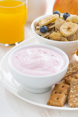 healthy breakfast - yogurt, cereal and juice, close-up
