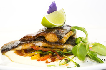 baked fish with vegetables and mushrooms in a restaurant