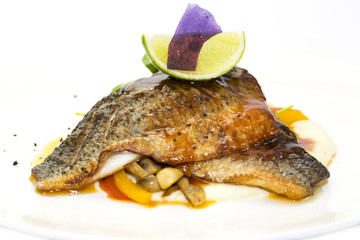 baked fish with vegetables and mushrooms in a restaurant
