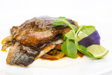 baked fish with vegetables and mushrooms in a restaurant