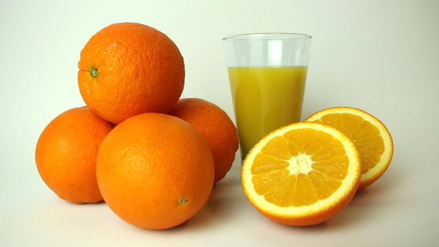 Ripe fresh oranges on a white background