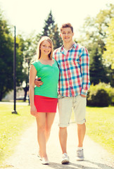 smiling couple walking in park