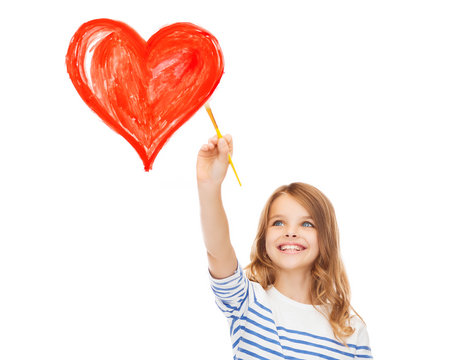 cute little girl drawing heart with brush