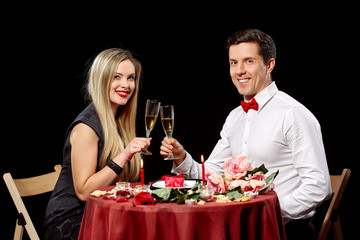 Portrait Of Romantic Couple Toasting white Wine At Dinner