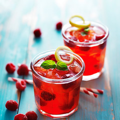 iced raspberry cocktail in two cups with mint and lemon