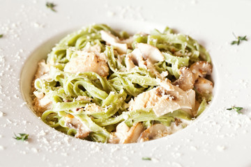 Italian pasta with sauce and parmesan cheese, served on a white 