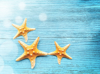 Fototapeta na wymiar Starfish on the wooden blue background.
