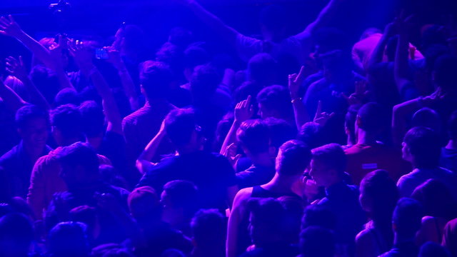 Crowd of young people dancing on party, slowmotion