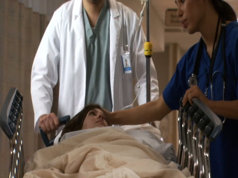 Female nurse explaining to female patient on diagnostic bed