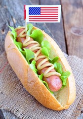 hotdog sandwich with yellow mustard sauce and lettuce