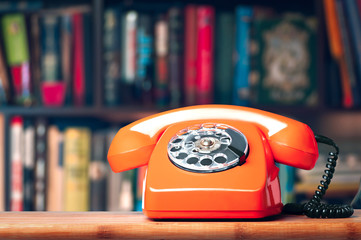 Vintage phone in the office on the bookshelf background