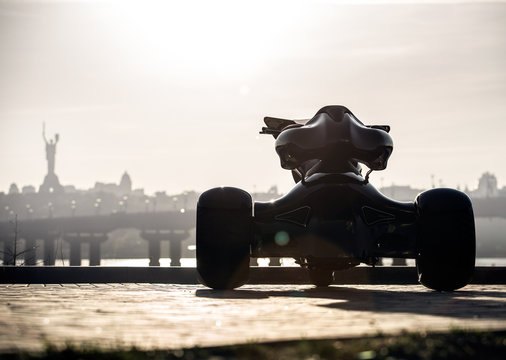 Black trike standing on the light street