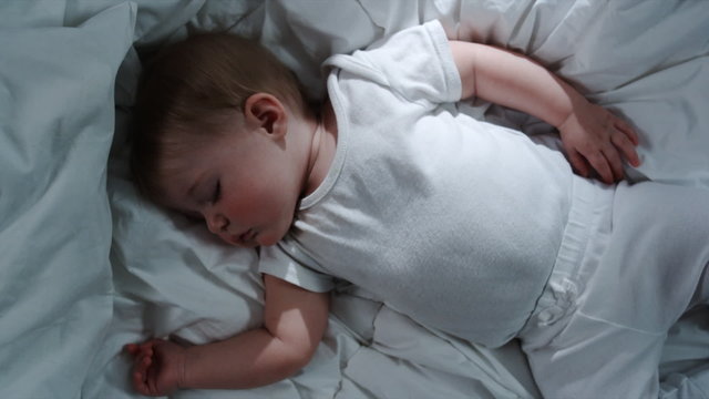 baby asleep on a bed