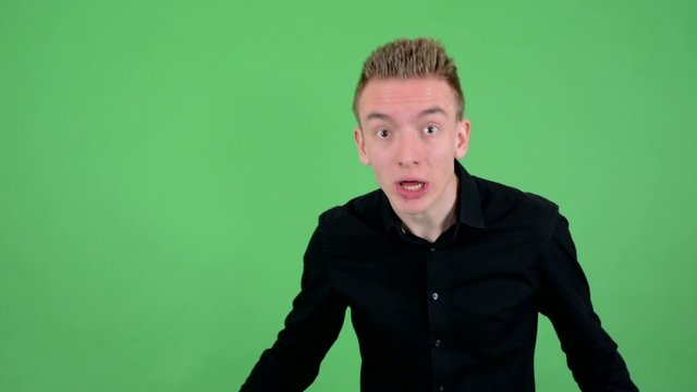young handsome man is angry - green screen - studio
