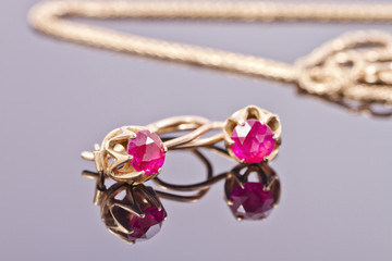 Small gold earrings with semi-precious stones ruby color