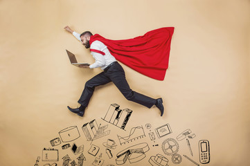 Manager in a cloak of superman. Studio shot on beige background - obrazy, fototapety, plakaty