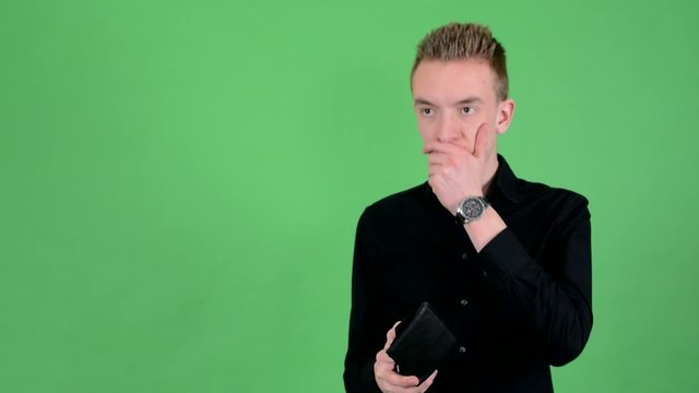 man looks to wallet and have depresssion - green screen - studio