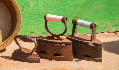 Three vintage cast-iron iron