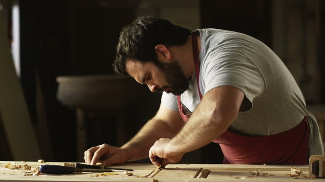 carpenter woodworking on a door