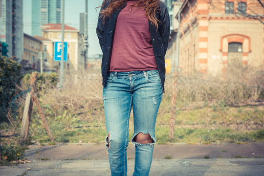 Detail of a girl posing in an urban context