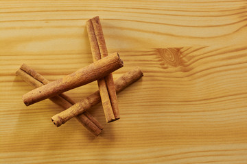 Cinnamon sticks on a wooden cutting board