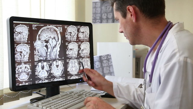 Doctor in Hospital Examining CT scan