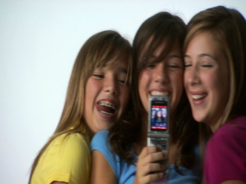 Three tweens with cell phones