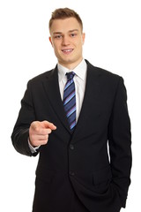 Young smiling businessman in suit shows on you