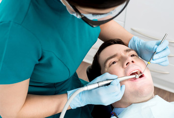 Man getting a dental checkup - Powered by Adobe