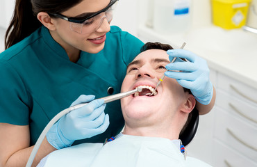 Male getting his teeth examined.
