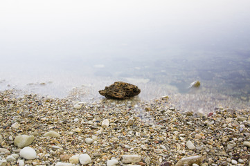 large stone in a dim foggy water