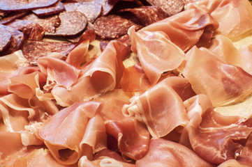 Sliced dry sausages and prosciutto