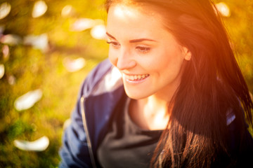Fototapeta premium Beautiful girl on green summer grass, smiling and happy