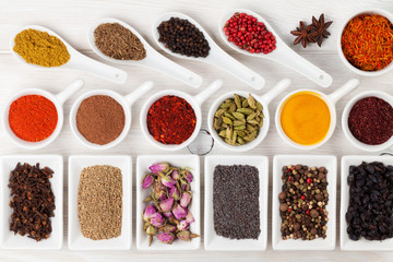 Various spices on white wooden background