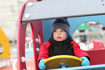 Boy driving wooden car